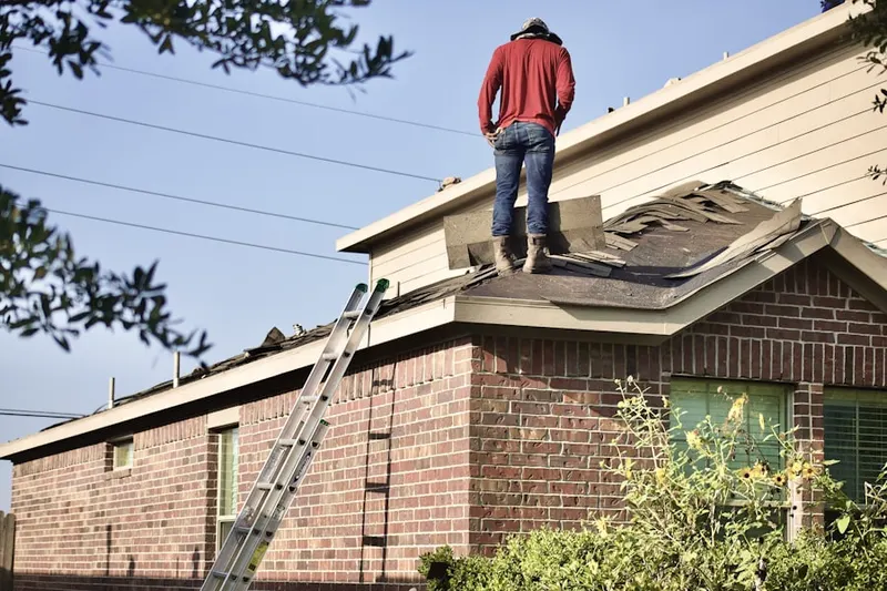 Professional roofer working on a residential roof in White Post